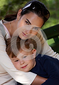 Mother and son cuddling outdoor