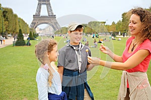 Mother, son and daughter with lollipops near in