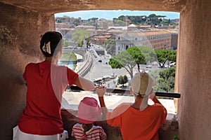 Mother, son and daughter looking through window