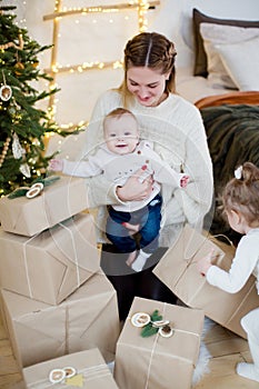 Mother, son, daughter near Christmas tree