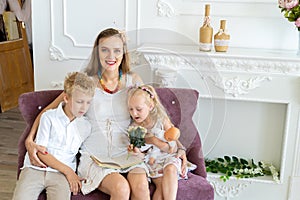 Mother son and daughter read book