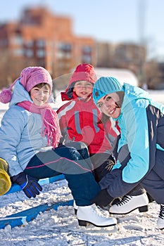 Mother with son and daughter at the skating rink