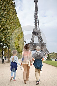 Mother, son and daughter walk in the park near the