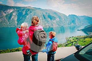 Mother with son and daugther travel by car in nature