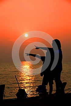 Mother and son in a deep moment of love during sunset at beach