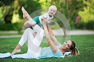 Mother and son doing exercise outdoors. Healthy lifestyle. Yoga