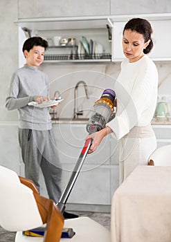 Mother and son doing household chores