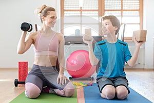 Mother and son doing weight training at home during lockdown curfew