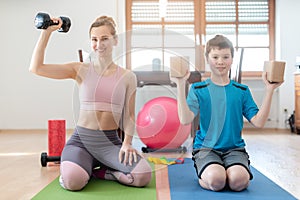 Mother and son doing weight training at home during lockdown curfew