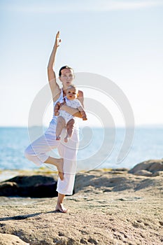 A mother and a son are doing yoga exercises