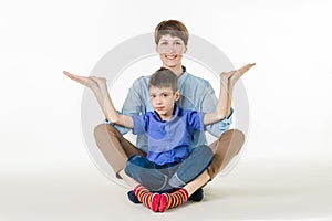 Mother and son doing yoga, spending a good time together . on white.