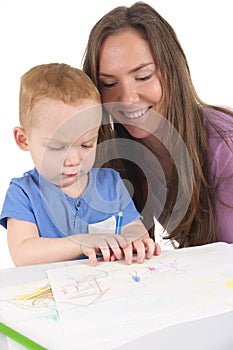 Mother and son are drawing the picture together