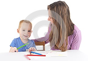 Mother and son are drawing the picture together