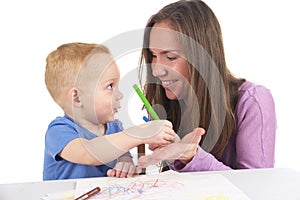 Mother and son are drawing the picture together