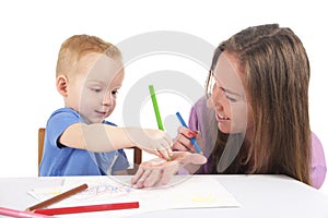 Mother and son are drawing the picture together