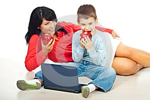 Mother and son eating apples