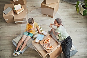 Mother and Son Eating Pizza in New Home High Angle