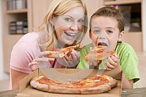 Mother And Son Eating Pizza Together