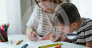 Mother and son engaging in drawing activity at home