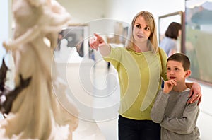 Mother and son enjoying expositions in museum