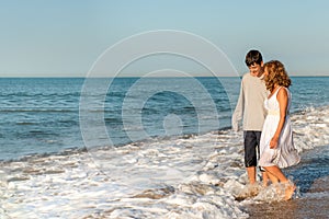 Mother and son enjoying a walk on the beach