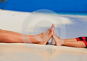 Mother and son feet on summer beach