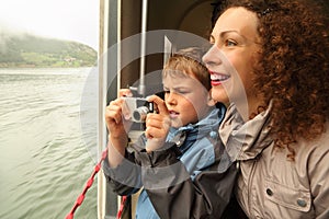 Mother with son float at passengers vessel
