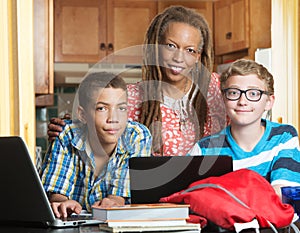 Mother with son and friend doing homework