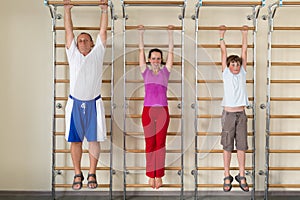 mother son and grandfather hanging on a horizontal