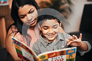 Mother, son and happy with book, learning and reading together with support, care and love in family home. Woman, boy