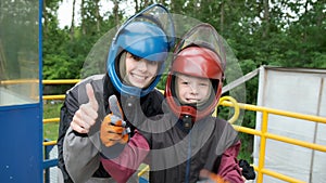 Mother and son are happy and showing thumbs up after flying in aero tube.