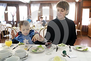 Mother with son have supper