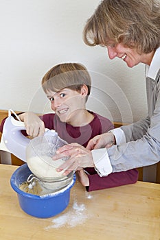 Mother and son having fun in kitchen
