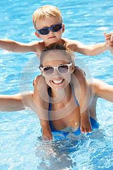 Mother And Son Having Fun In Swimming Pool