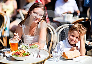 Mother and son having lunch in sidewalk restaurant