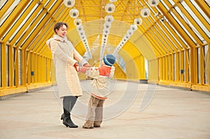 Mother and son hold each other for hands