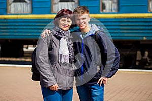 Mother and son hugging after long separation at railway station