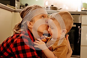 Mother and son in kitchen at home