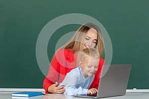 Mother and son learning. Online school. Teacher helping school child, online learning webinar using laptop in class at