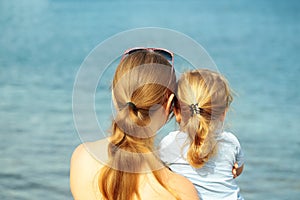 Mother and son look at sea