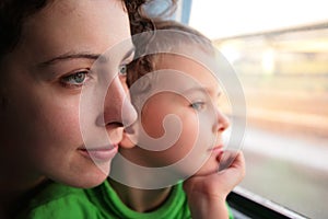 Mother and son look in window