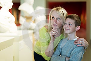 Mother and son looking at classical statues