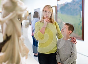 Mother and son looking at expositions in museum