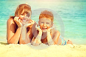 Mother and son lying at the beach