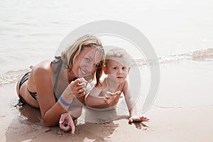 Mother and son lying on the sand