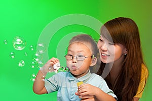 Mother and son make soap bubbles