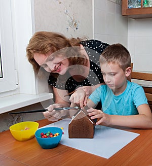 Mother and son making gingerbread house
