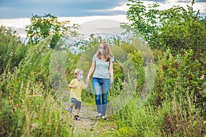 Mother and son in a medical mask because of an allergy to ragweed