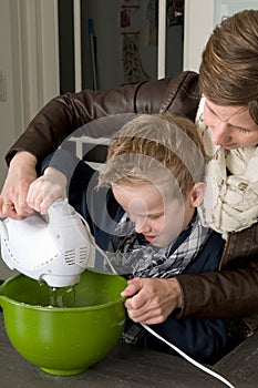 Mother and son mixing the dough