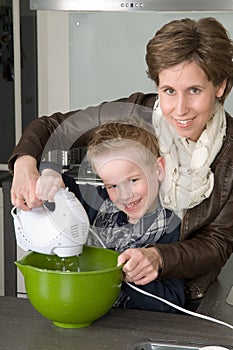 Mother and son mixing the dough